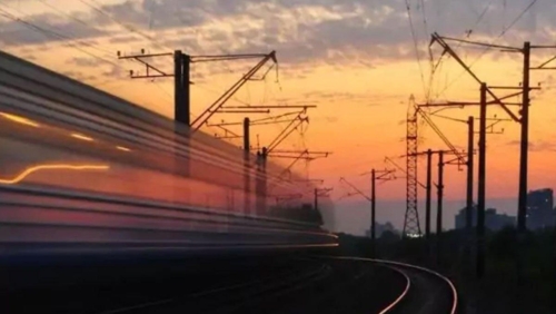 a train traveling down the tracks at sunset