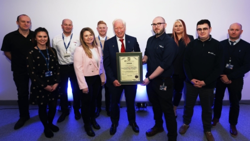 employees receiving an award from John Neill