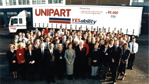 a group of people in front of a Unipart branded HGV for the Unipart Yes Ability Cancer Research campaign