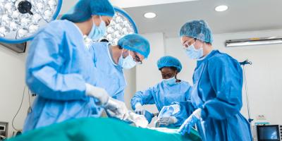 Doctor and assistant nurse operating for help patient from dangerous emergency case .Surgical instruments on the sterile table in the emergency operation room in the hospital.Health care and Medical