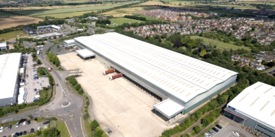 An aerial view from the sky of our Warth Park warehouse. It is surrounded by green fields, and houses